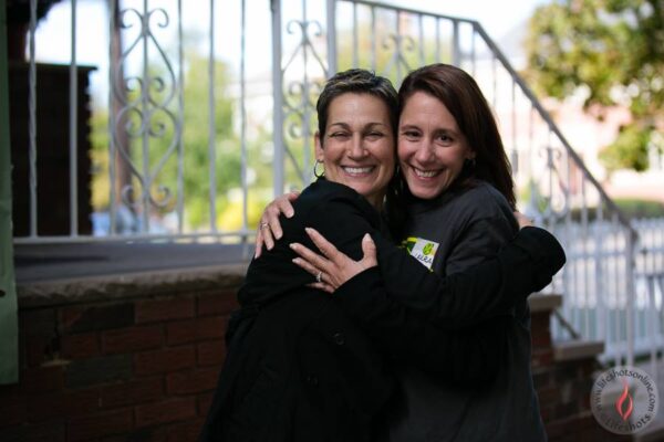 Executive Director Phyllis Adams embraces a volunteer